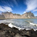 Stokksnes with clear blue sky and few white clouds