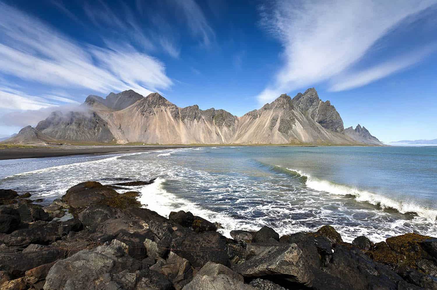 Stokksnes with clear blue sky and few white clouds